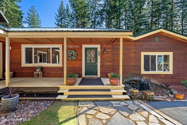 entrance to property featuring metal roof and covered porch