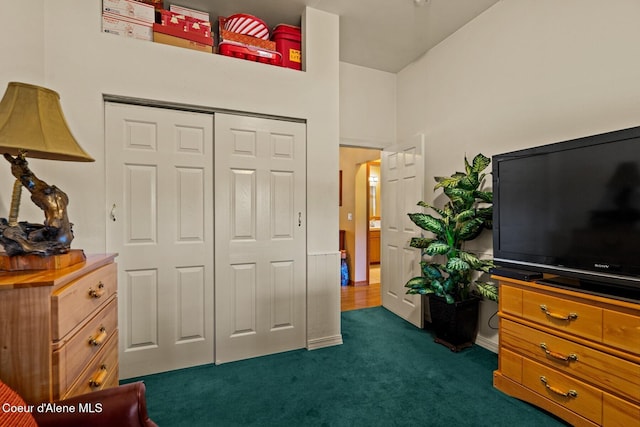 bedroom featuring dark carpet and a closet