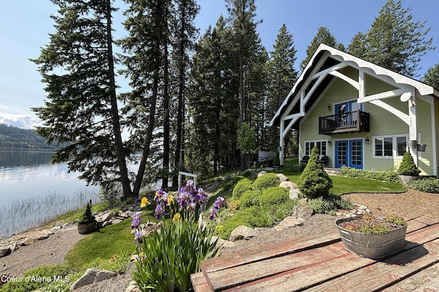 307 Quinns Ln, Cocolalla, ID 83813 - back of house featuring a balcony, a water view, and a lawn
