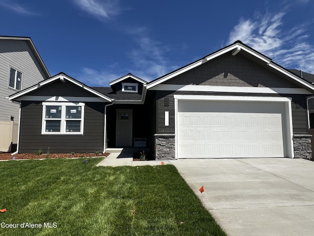 3384 N Cyprus Fox Loop, Post Falls, ID 83854 - craftsman inspired home featuring a garage, driveway, stone siding, and a front lawn