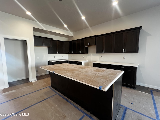 3384 N Cyprus Fox Loop, Post Falls, ID 83854 - kitchen with baseboards, a center island, light countertops, and vaulted ceiling