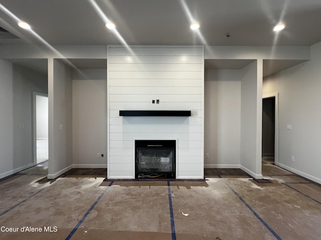 3384 N Cyprus Fox Loop, Post Falls, ID 83854 - unfurnished living room featuring baseboards and a fireplace