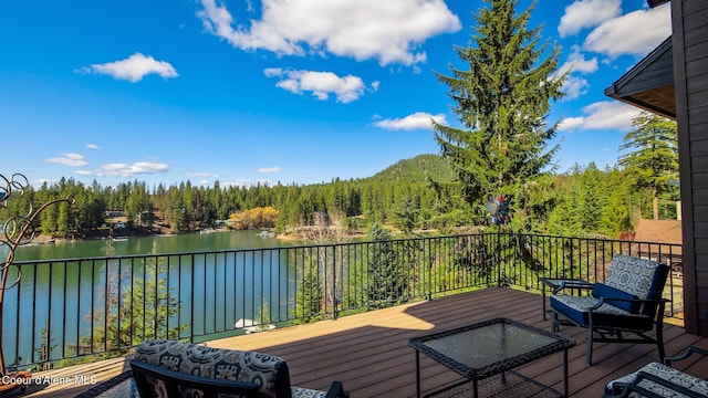 7431 E Cumberland Ct, Hayden, ID 83835 - wooden deck with a wooded view and a water view