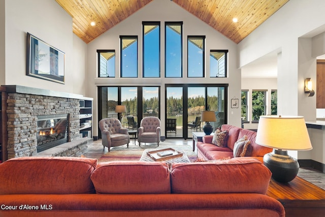 7431 E Cumberland Ct, Hayden, ID 83835 - living room with a fireplace, a towering ceiling, wood ceiling, and wood finished floors