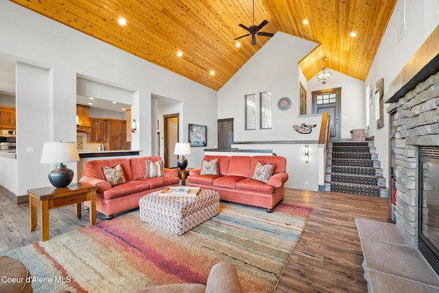 7431 E Cumberland Ct, Hayden, ID 83835 - living area with wood ceiling, wood finished floors, a ceiling fan, and a stone fireplace