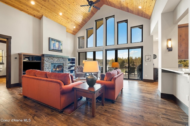 7431 E Cumberland Ct, Hayden, ID 83835 - living room featuring ceiling fan, high vaulted ceiling, a fireplace, a wealth of natural light, and dark wood-style flooring