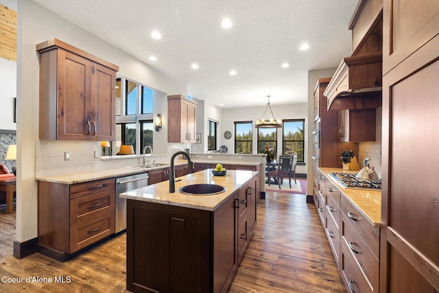 7431 E Cumberland Ct, Hayden, ID 83835 - kitchen with appliances with stainless steel finishes, recessed lighting, a peninsula, decorative backsplash, and a sink