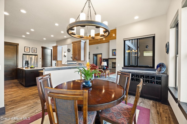 7431 E Cumberland Ct, Hayden, ID 83835 - dining area with wood finished floors, a notable chandelier, visible vents, and recessed lighting