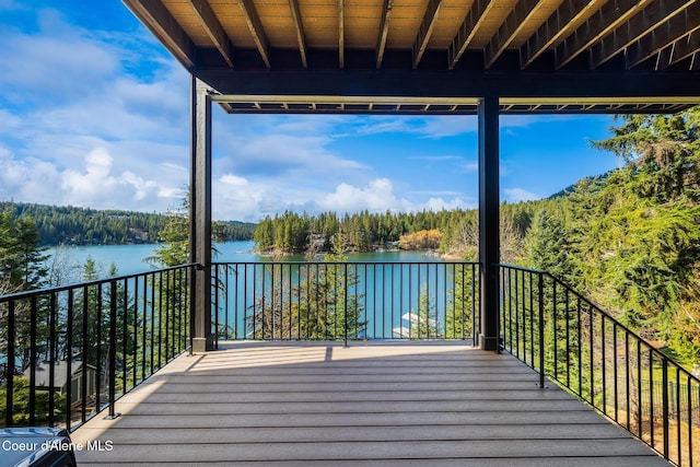 7431 E Cumberland Ct, Hayden, ID 83835 - deck featuring a water view and a wooded view