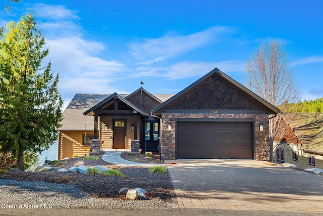 7431 E Cumberland Ct, Hayden, ID 83835 - view of front of house featuring stone siding, decorative driveway, and an attached garage