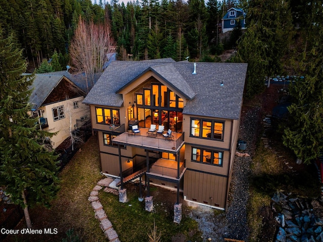7431 E Cumberland Ct, Hayden, ID 83835 - rear view of house featuring stairway, roof with shingles, and a forest view