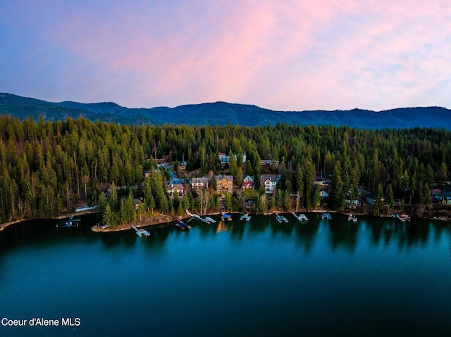 7431 E Cumberland Ct, Hayden, ID 83835 - birds eye view of property featuring a wooded view and a water and mountain view