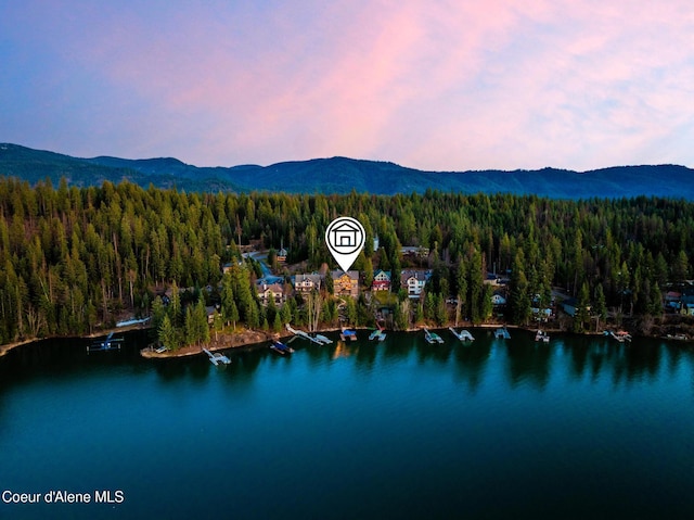 7431 E Cumberland Ct, Hayden, ID 83835 - aerial view featuring a wooded view and a water and mountain view