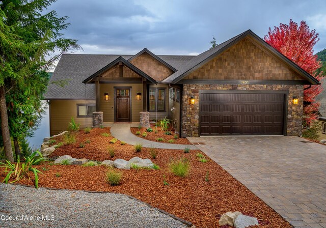 7431 E Cumberland Ct, Hayden, ID 83835 - craftsman inspired home with stone siding, a garage, and decorative driveway