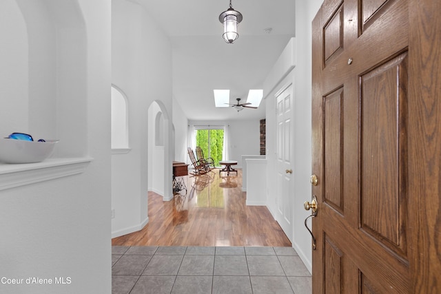 5660 N Loraine St, Coeur Dalene, ID 83815 - entrance foyer with light tile patterned floors, a skylight, and baseboards
