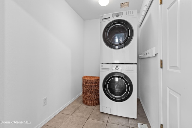 5660 N Loraine St, Coeur Dalene, ID 83815 - clothes washing area with light tile patterned floors, baseboards, visible vents, laundry area, and stacked washer and dryer