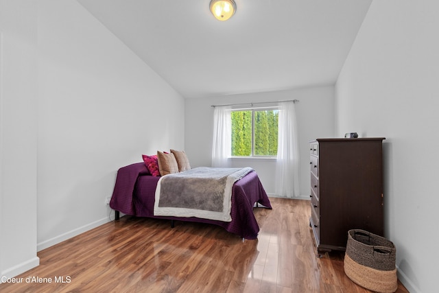 5660 N Loraine St, Coeur Dalene, ID 83815 - bedroom with baseboards, vaulted ceiling, and light wood-style floors