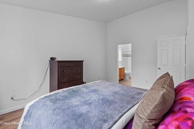 5660 N Loraine St, Coeur Dalene, ID 83815 - bedroom featuring baseboards and connected bathroom