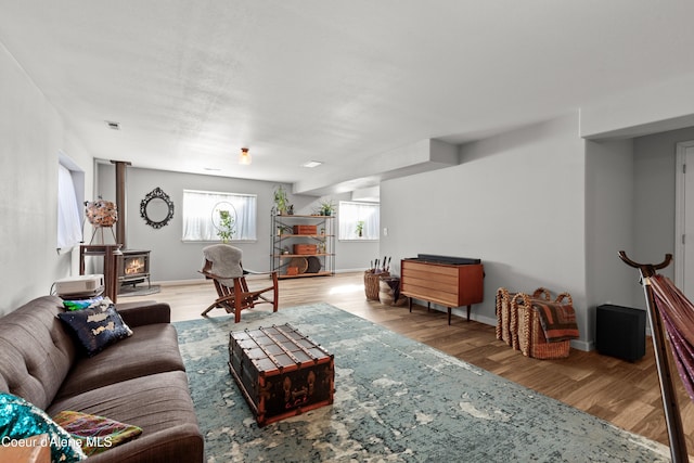 5660 N Loraine St, Coeur Dalene, ID 83815 - living area featuring visible vents, a wood stove, and wood finished floors