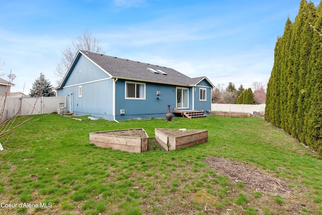 5660 N Loraine St, Coeur Dalene, ID 83815 - back of property featuring a garden, a yard, and a fenced backyard