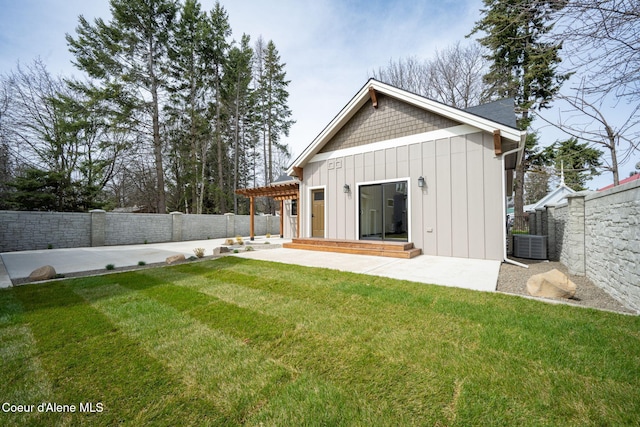 back of house featuring a patio, board and batten siding, a fenced backyard, and a lawn
