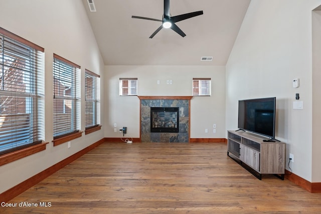 45 Welty Dr, Dover, ID 83825 - unfurnished living room with a tiled fireplace, visible vents, a ceiling fan, and wood finished floors