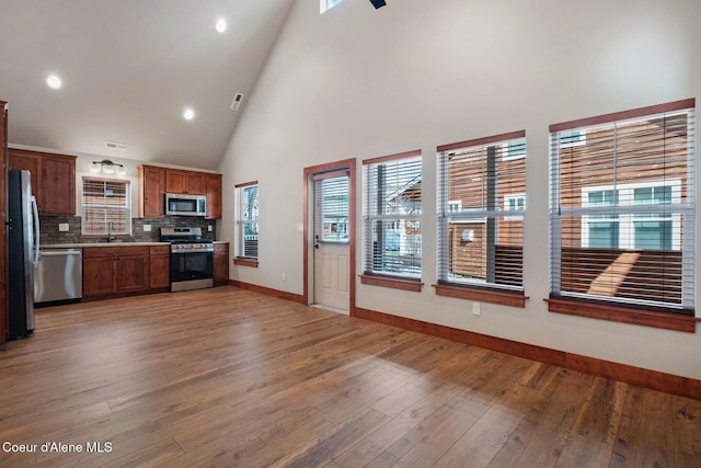 45 Welty Dr, Dover, ID 83825 - kitchen featuring baseboards, light countertops, appliances with stainless steel finishes, light wood-type flooring, and decorative backsplash