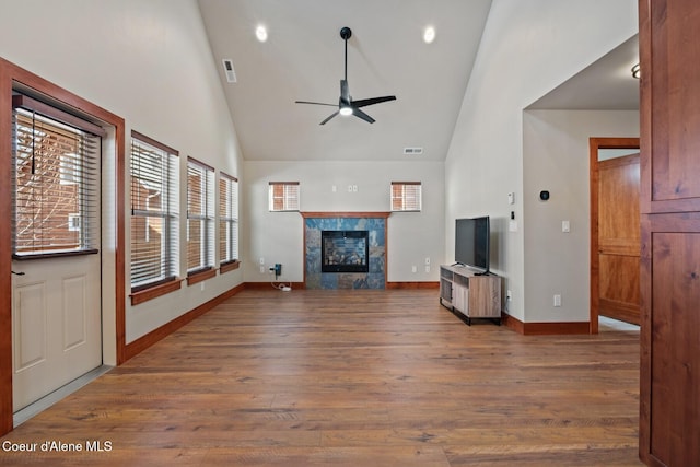 45 Welty Dr, Dover, ID 83825 - unfurnished living room with a tile fireplace, high vaulted ceiling, a ceiling fan, and wood finished floors