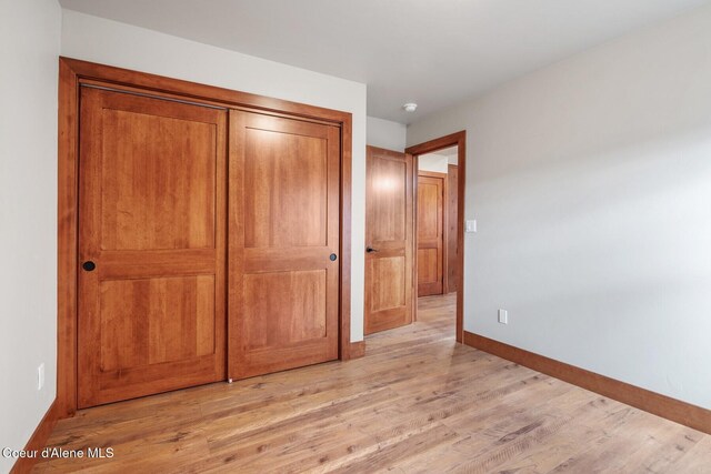 45 Welty Dr, Dover, ID 83825 - unfurnished bedroom featuring a closet, light wood finished floors, and baseboards