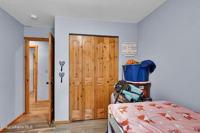 181 E Deer Meadow Ln, Blanchard, ID 83804 - bedroom with light wood-style flooring, a closet, and baseboards