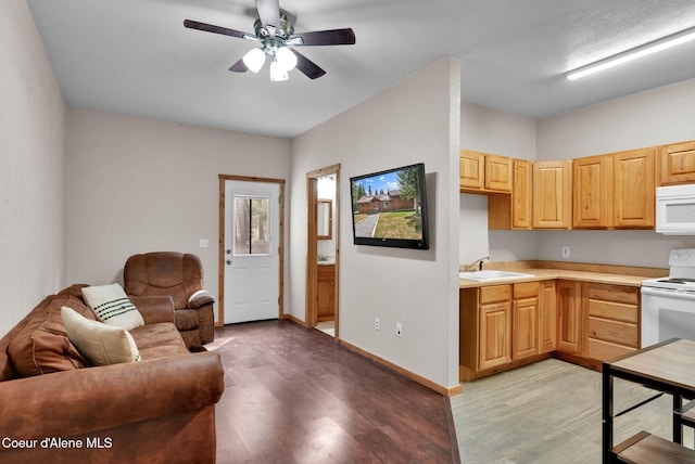 181 E Deer Meadow Ln, Blanchard, ID 83804 - kitchen with ceiling fan, white appliances, light countertops, a sink, and light brown cabinets