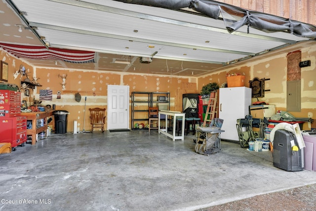 181 E Deer Meadow Ln, Blanchard, ID 83804 - garage with electric panel, a workshop area, and a garage door opener