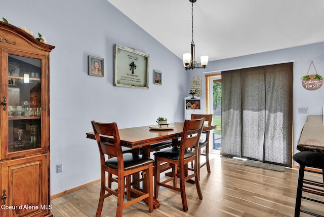 181 E Deer Meadow Ln, Blanchard, ID 83804 - dining space with light wood-style flooring, an inviting chandelier, baseboards, and lofted ceiling