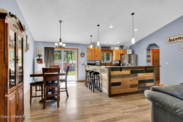 181 E Deer Meadow Ln, Blanchard, ID 83804 - dining area with light wood-type flooring, vaulted ceiling, an inviting chandelier, and recessed lighting