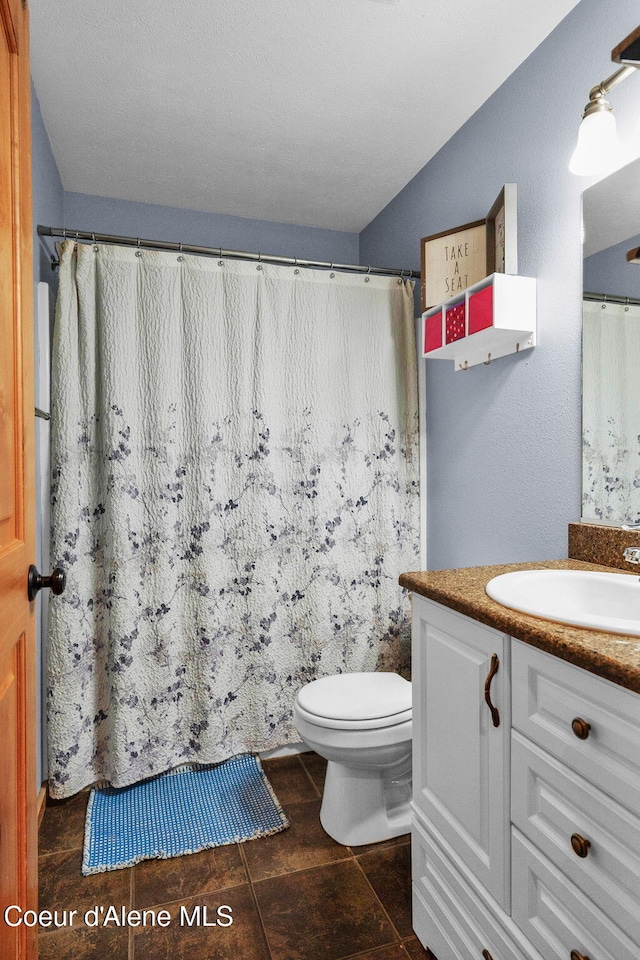 181 E Deer Meadow Ln, Blanchard, ID 83804 - full bathroom with toilet, curtained shower, and vanity