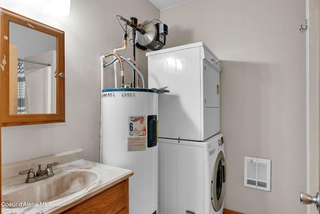 181 E Deer Meadow Ln, Blanchard, ID 83804 - laundry room featuring laundry area, visible vents, water heater, stacked washer / dryer, and a sink