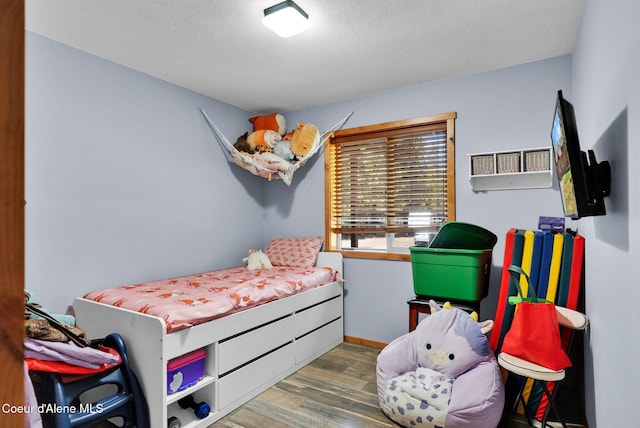 181 E Deer Meadow Ln, Blanchard, ID 83804 - bedroom with a textured ceiling, baseboards, and wood finished floors