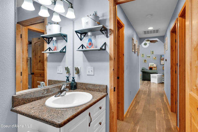 181 E Deer Meadow Ln, Blanchard, ID 83804 - bathroom featuring vanity, visible vents, and hardwood / wood-style flooring