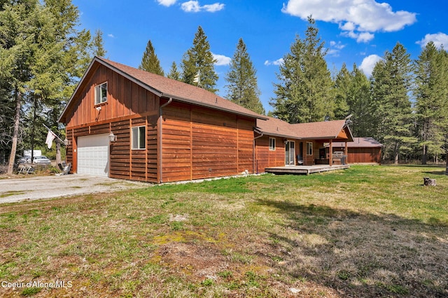 181 E Deer Meadow Ln, Blanchard, ID 83804 - exterior space with board and batten siding, a yard, a detached garage, driveway, and a deck