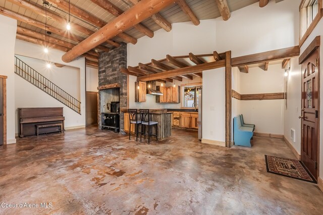 164 Generations Dr, Athol, ID 83801 - living area with wooden ceiling, baseboards, beam ceiling, and unfinished concrete floors