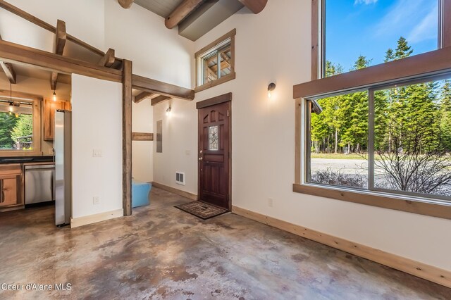 164 Generations Dr, Athol, ID 83801 - entrance foyer featuring a towering ceiling, a wealth of natural light, visible vents, beam ceiling, and concrete flooring