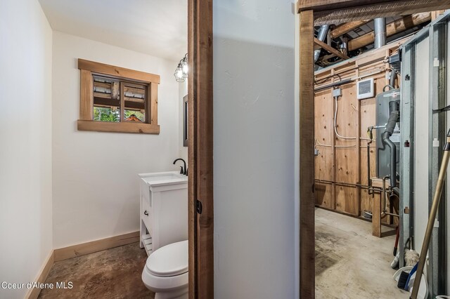 164 Generations Dr, Athol, ID 83801 - half bathroom featuring concrete flooring, toilet, vanity, and baseboards
