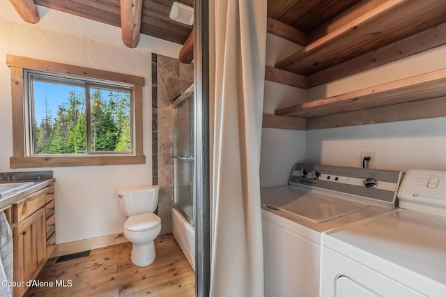 164 Generations Dr, Athol, ID 83801 - interior space featuring wooden ceiling, separate washer and dryer, toilet, beam ceiling, and wood finished floors