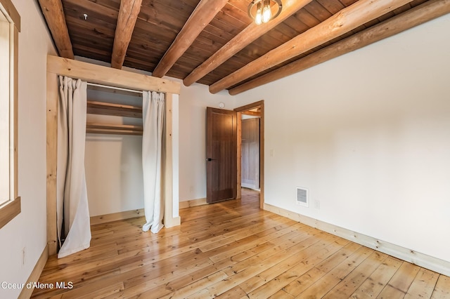 164 Generations Dr, Athol, ID 83801 - unfurnished bedroom with light wood-type flooring, a closet, visible vents, wooden ceiling, and beam ceiling