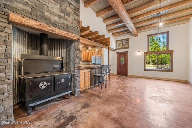 164 Generations Dr, Athol, ID 83801 - living area with baseboards, concrete floors, wood ceiling, and beamed ceiling