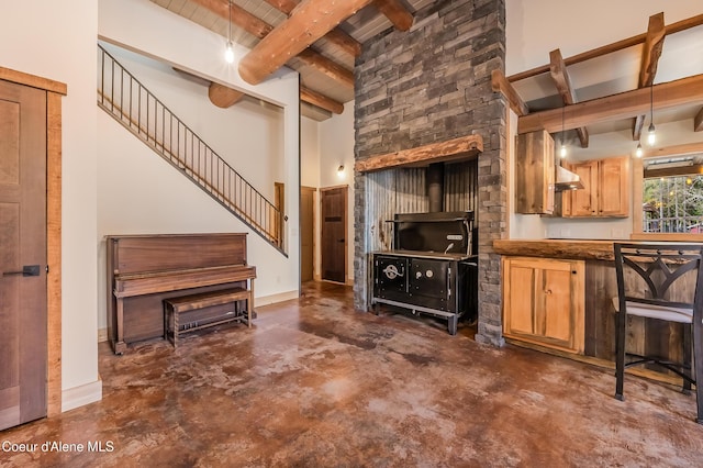 164 Generations Dr, Athol, ID 83801 - living room featuring stairway, concrete floors, baseboards, and beamed ceiling