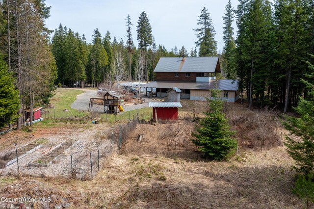 164 Generations Dr, Athol, ID 83801 - rear view of house with a wooded view and metal roof