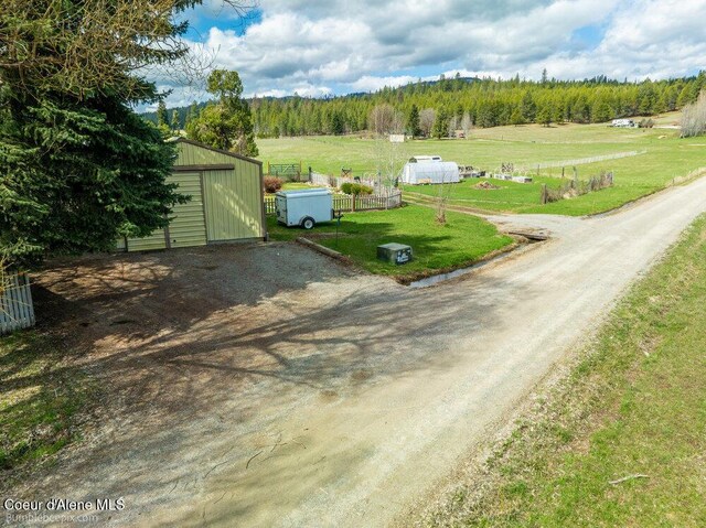 birds eye view of property with a rural view