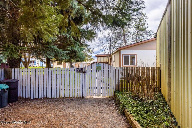 view of yard featuring fence and a gate