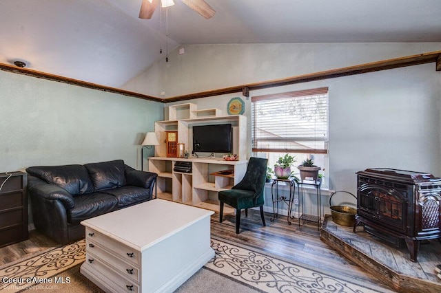 living room featuring a wood stove, light wood-style flooring, vaulted ceiling, and ceiling fan